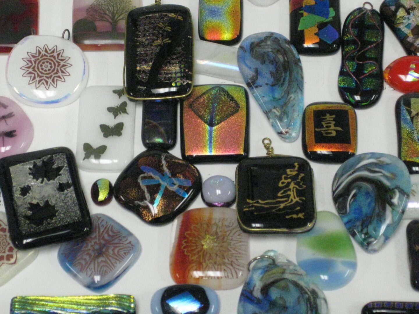 Assorted decorative glass stones with various colors and designs.