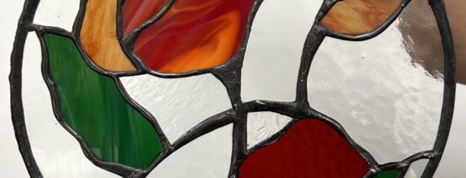 Stained glass with colorful floral design.